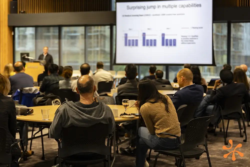 Attendees watching a talk with slides on screen