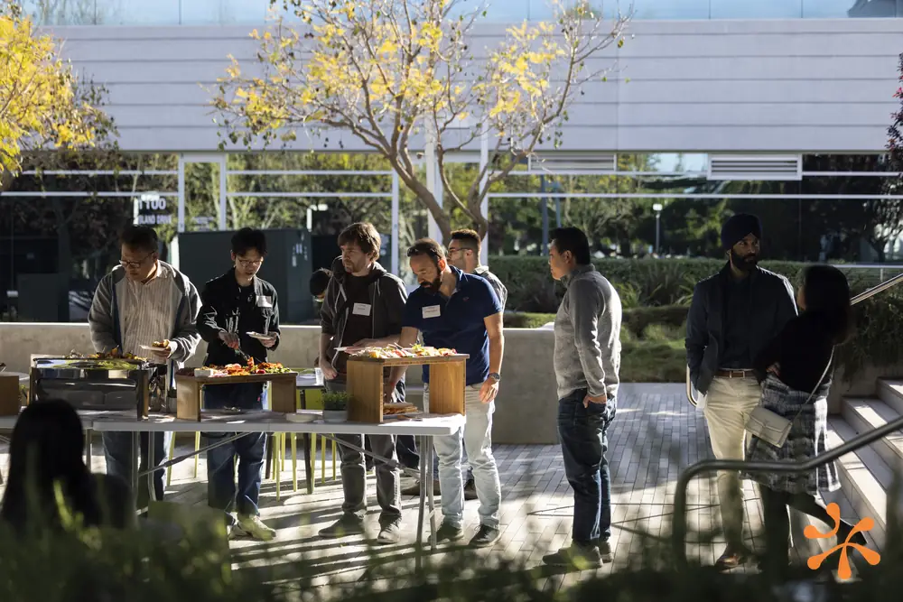 Attendees networking over food outdoors