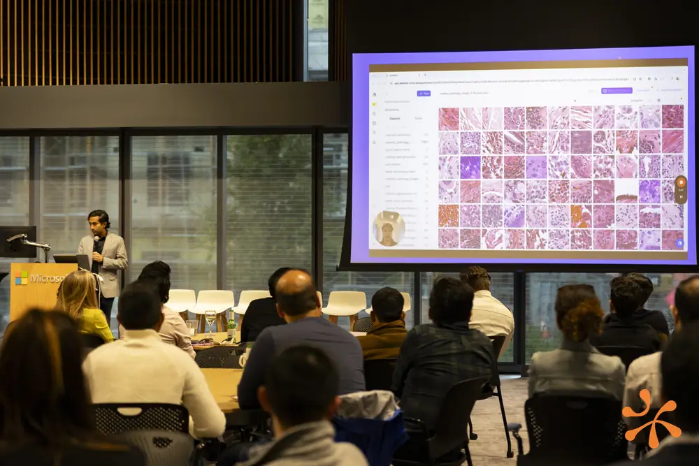 Speaker presenting pathology image analysis to the audience