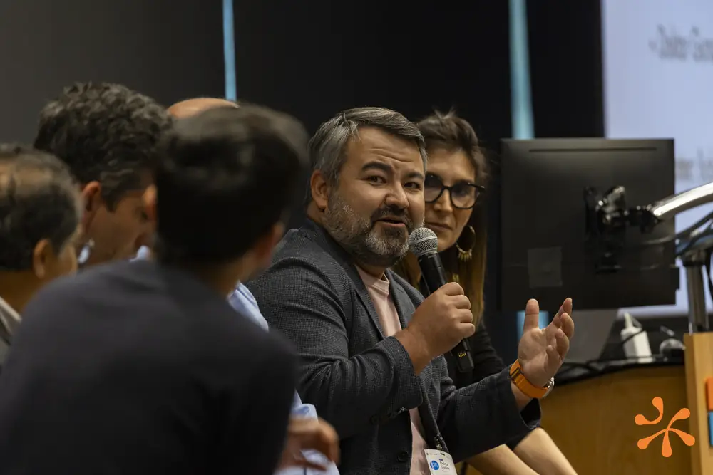 A panelist speaking into a microphone during Q&A